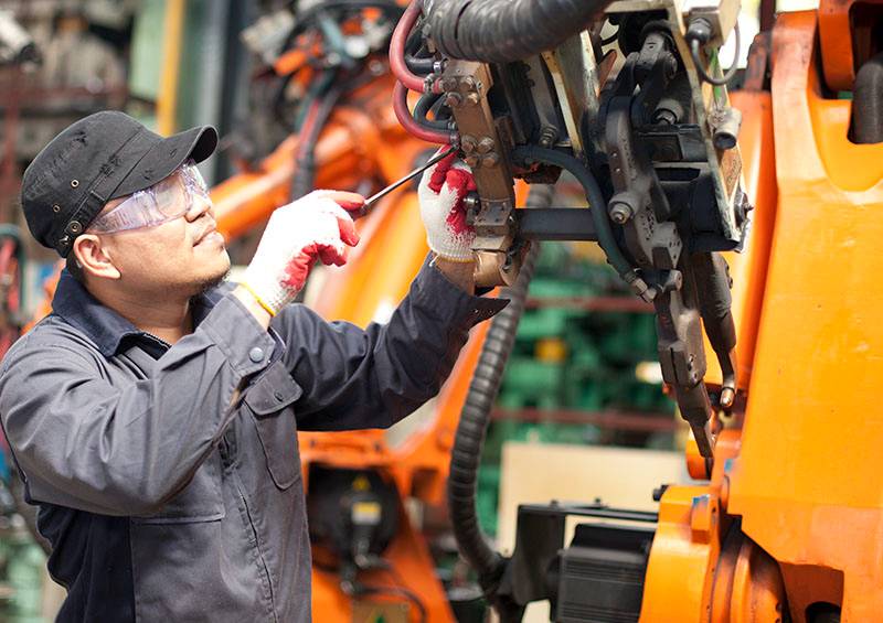 Mechanic repairing a robot machine