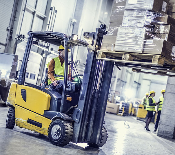Forklift moving stack of boxes