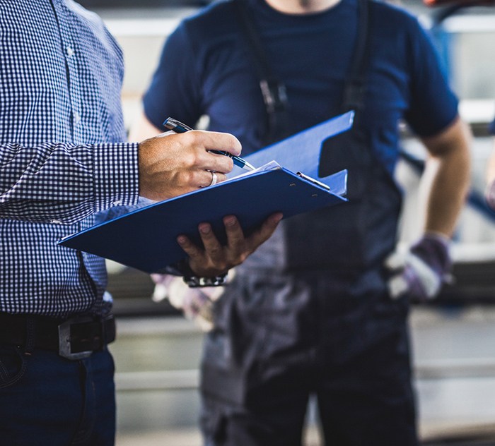Project manager demonstrates Project Management software in a manufacturing shop