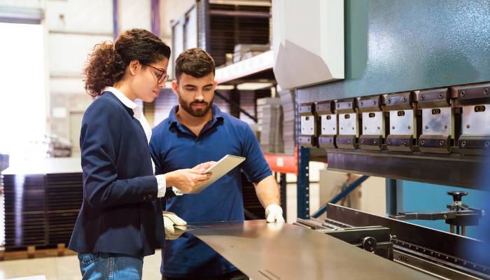 two people looking at sheet metal fabrication