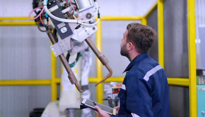 Automation manufactrer working on robot with ipad