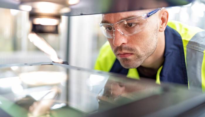 Engineer working on a robot Manufacturing ERP trends 2025