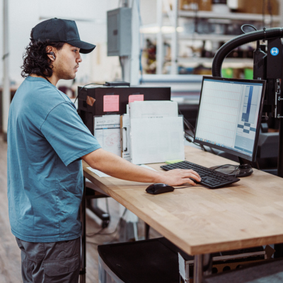 worker standing in front of a computer