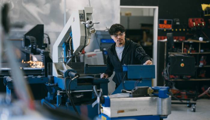 Manufacturing worker in plant with the aid of a full-suite ERP